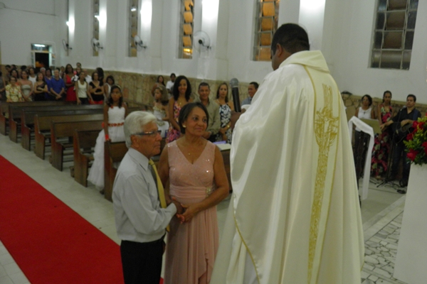O casal  reforça o juramento de amor eterno na presença do padre